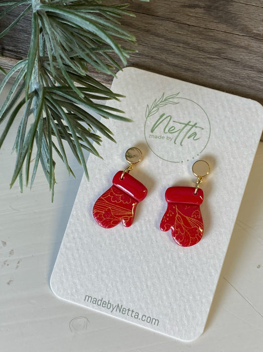 Røde votter med gullmønster